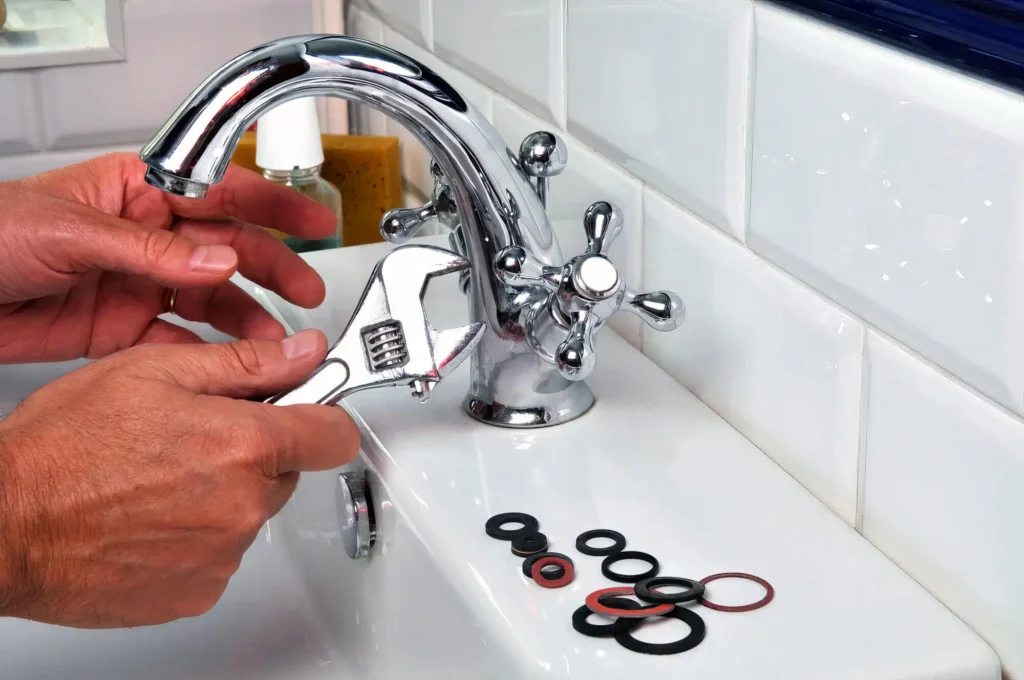 Plumber performing maintenance on a bathroom faucet in Margate