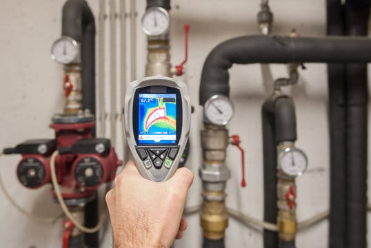 Plumber using a thermal imaging camera to inspect pipes in Margate