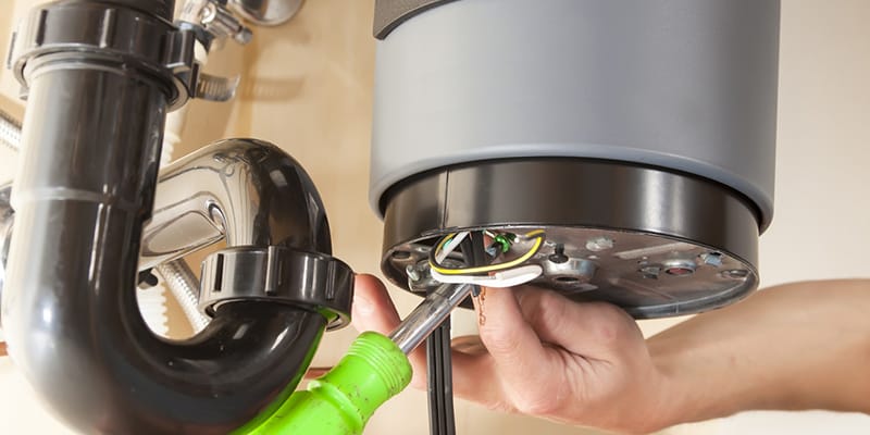 Technician repairing the heating element of a water heater in Margate